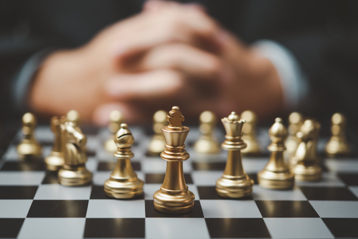 Strategic planning and goals success business idea. Businessman looking at chess at the board.