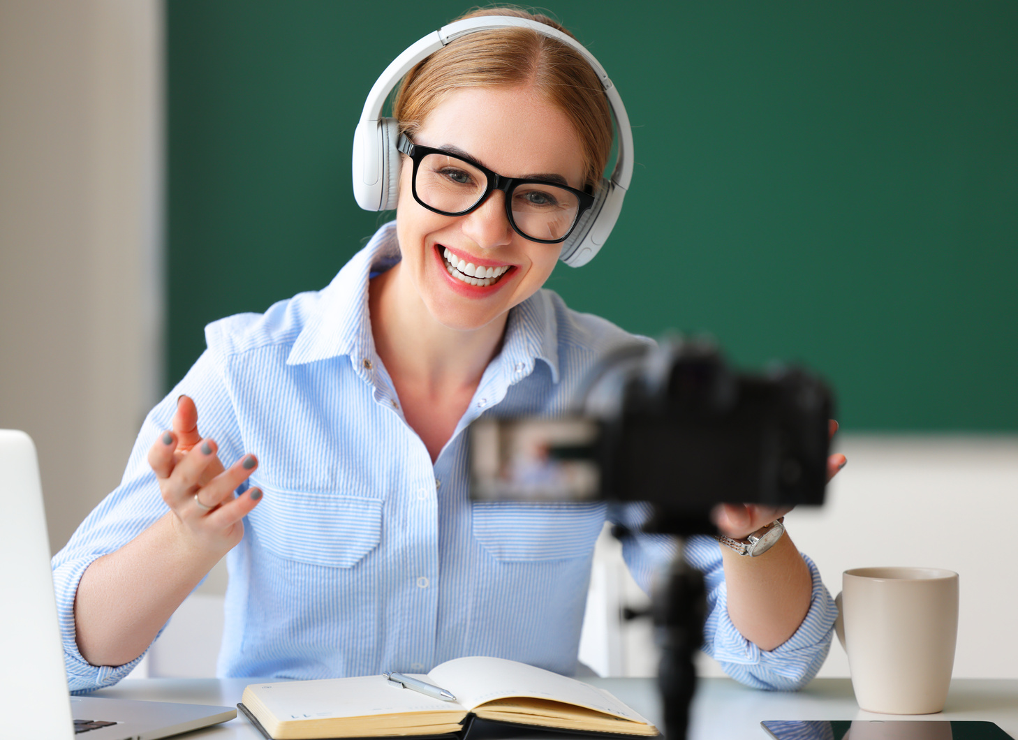 Delighted teacher recording online lesson